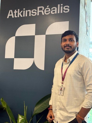 Vikas standing in front of Atkinsrealis logo